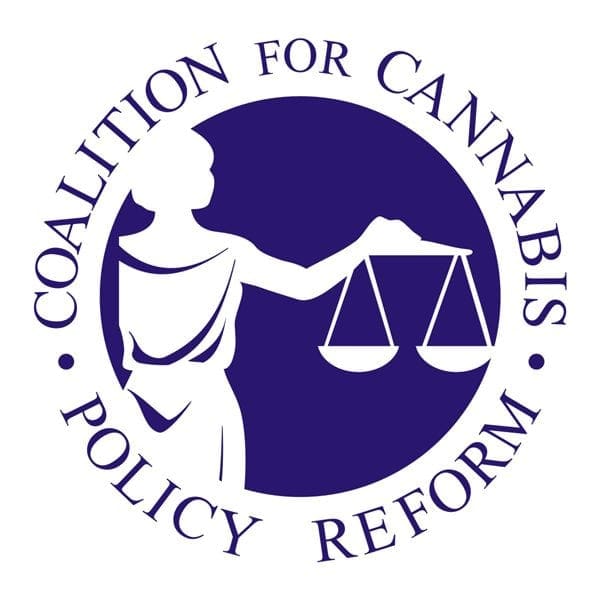 A circular logo with dark blue text and artwork reads "Coalition for Cannabis Policy Reform" in a circular layout. At the center, an illustration of a woman holding balanced scales symbolizes justice, underscoring the CCPR Unity Initiative. CA Norml