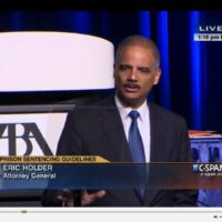 Attorney General Eric Holder speaks at a podium with "Prison Sentencing Guidelines" displayed, addressing the SF ABA Meeting. The event, broadcast live on C-SPAN with an ABA logo in the background, focuses on mandatory minimum drug-crime sentences. "1:16 pm ET" is shown at the top right corner. CA Norml