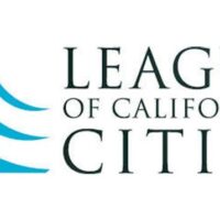 Logo design of the League of California Cities. The abstract, curved blue shape on the left resembles waves or a stylized letter "L" in a box. Prop. 64 initiatives like Cannabis Commerce are pivotal to their mission. The organization's name is written in uppercase serif font to the right of the graphic element. CA Norml