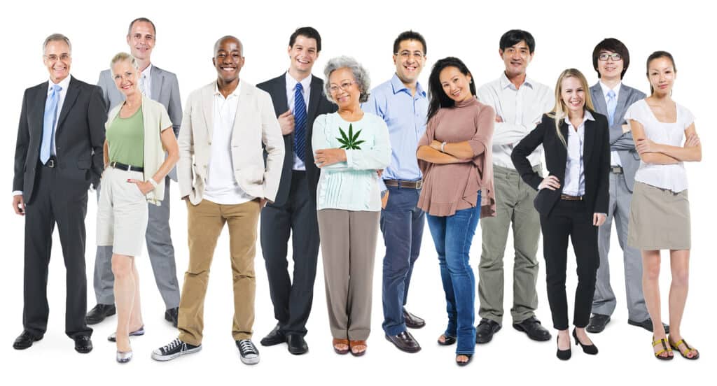 A diverse group of 12 adults posing for a photo against a white background. They are wearing various types of clothing, from casual to formal. One person is holding a cannabis leaf, sparking discussions about evolving policy. The group includes a mix of genders, ages, and ethnic backgrounds. CA Norml