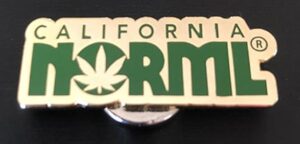 A pin celebrating California NORML's 2020 accomplishments, featuring the text "Cal NORML," with the "O" stylized as a cannabis leaf. The text is in green on a gold background. The pin has a shiny, metallic appearance. CA Norml
