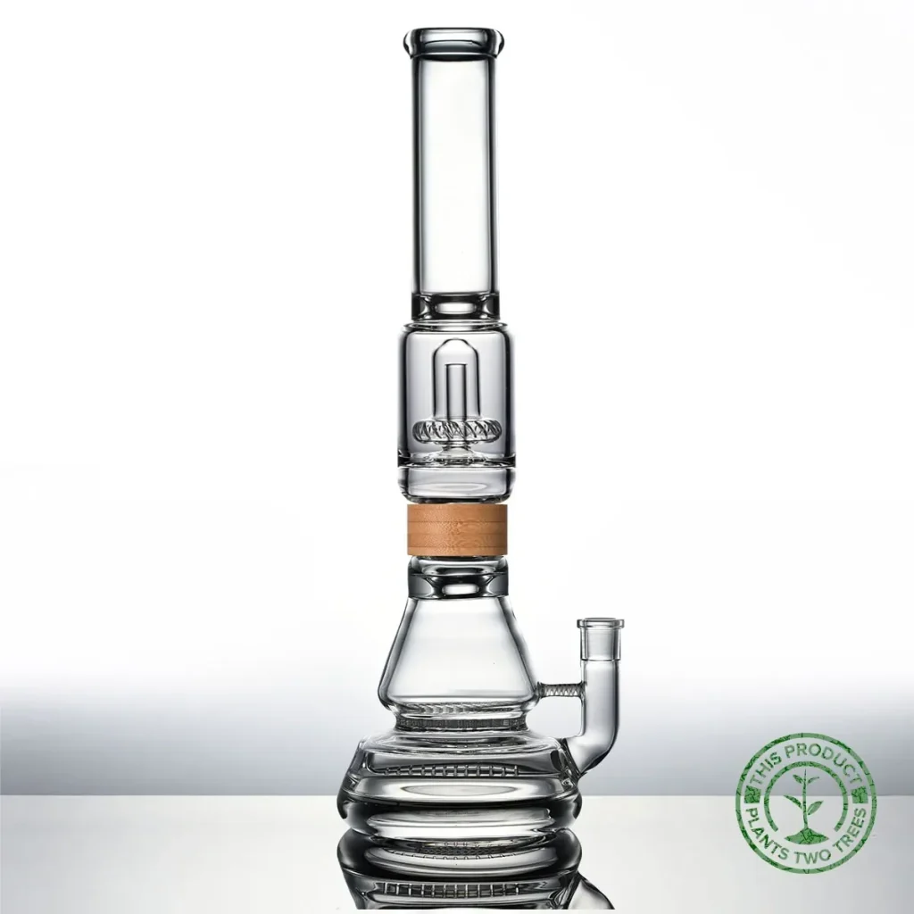 A clear glass water bong with a beaker base, straight neck, and a wooden accent around the middle, shown on a reflective surface. A green "Plants Two Trees" seal is in the bottom right corner. Ca NORML