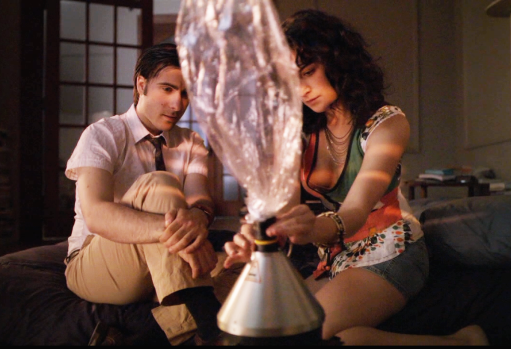 Jonathan (Jason Schwartzman) and Stella (Jenny Slate) use a vaporizer in the HBO Series "Bored to Death."