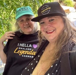 Ellen Komp of Cal NORML and Amy Fisher of the Traveling Hemp Museum don Oakland Equity Label gear.